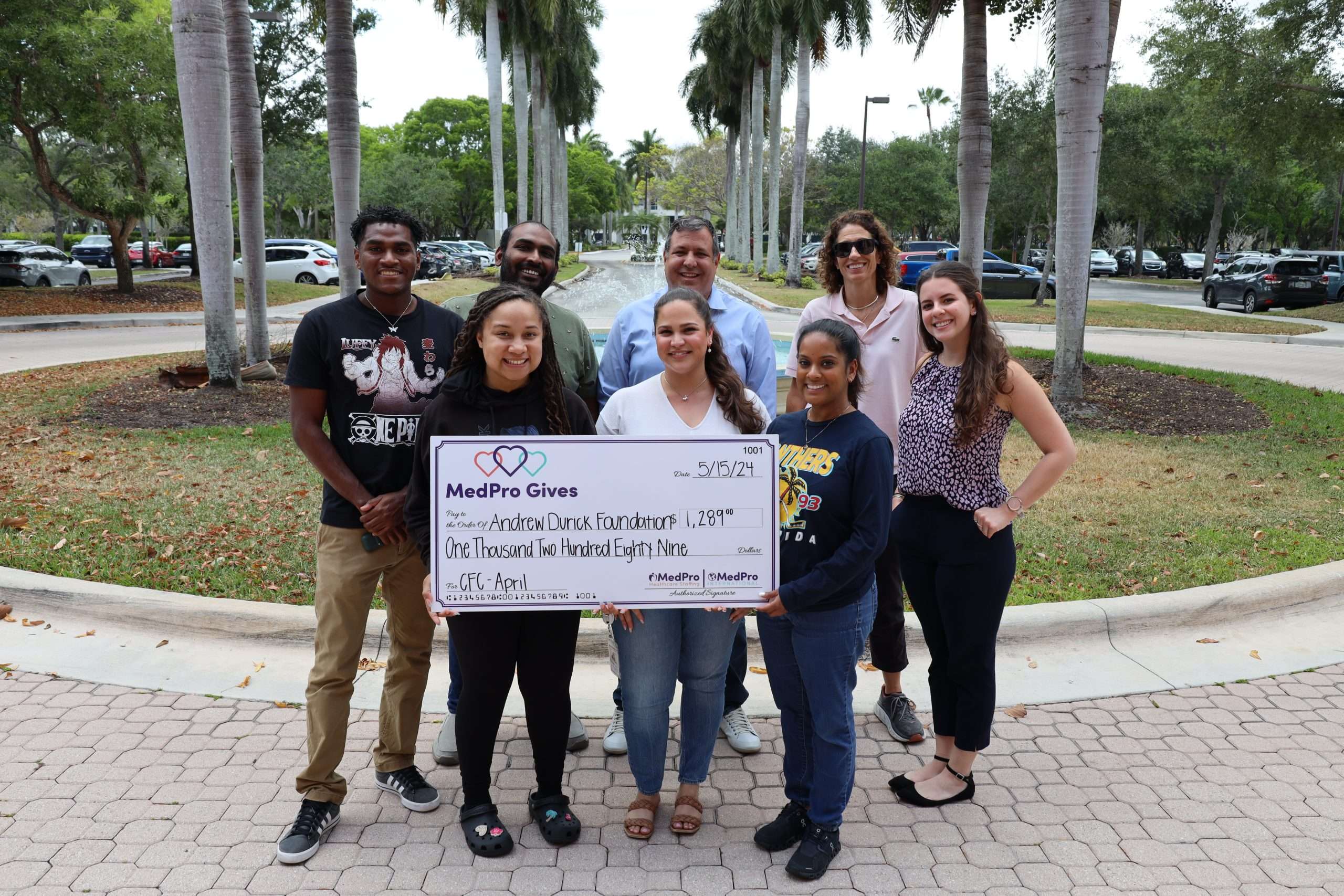 Team Member accepting MedPro’s Cocktails for Charity Check