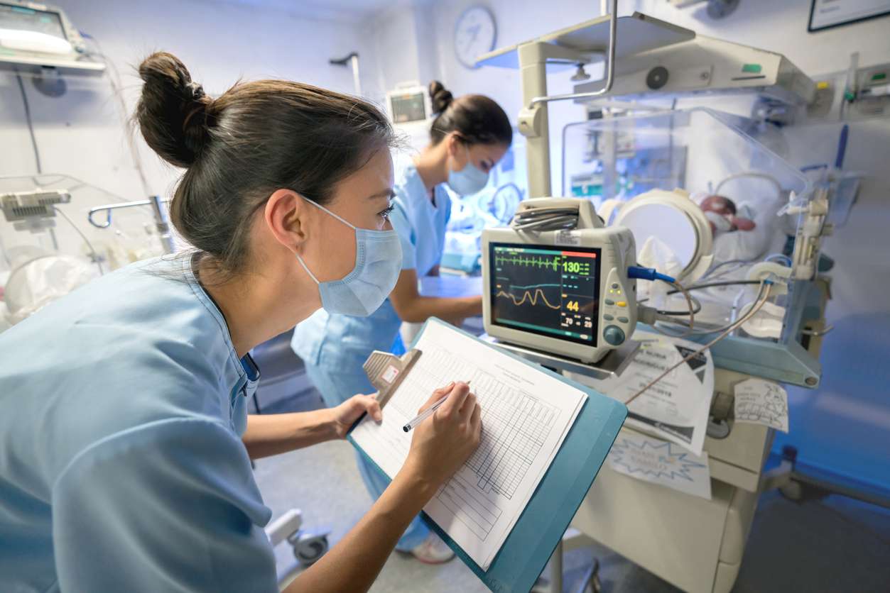 medical profession checking and recording vitals from a monitor image