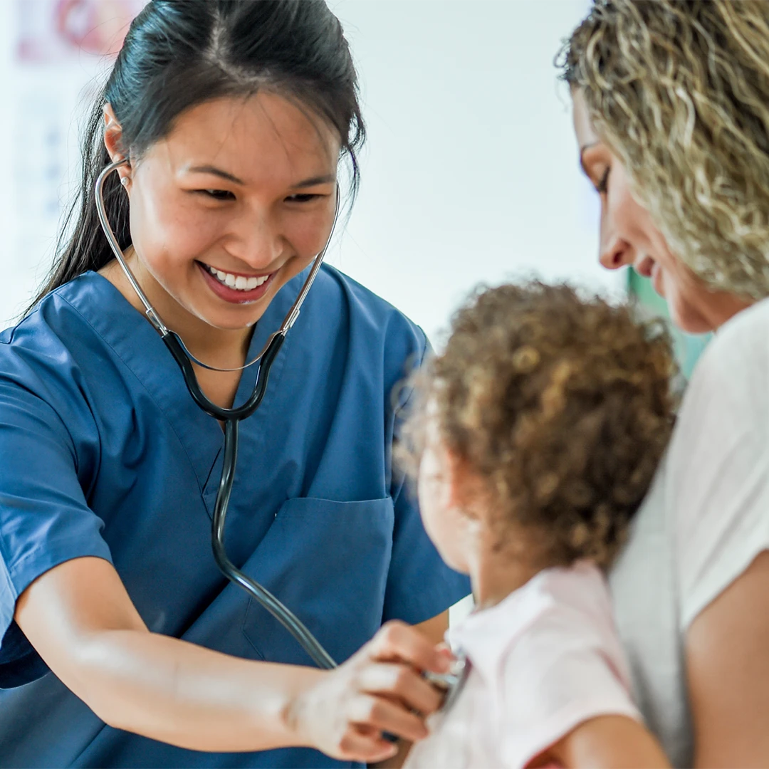 Travel Nurse performing check up on small child