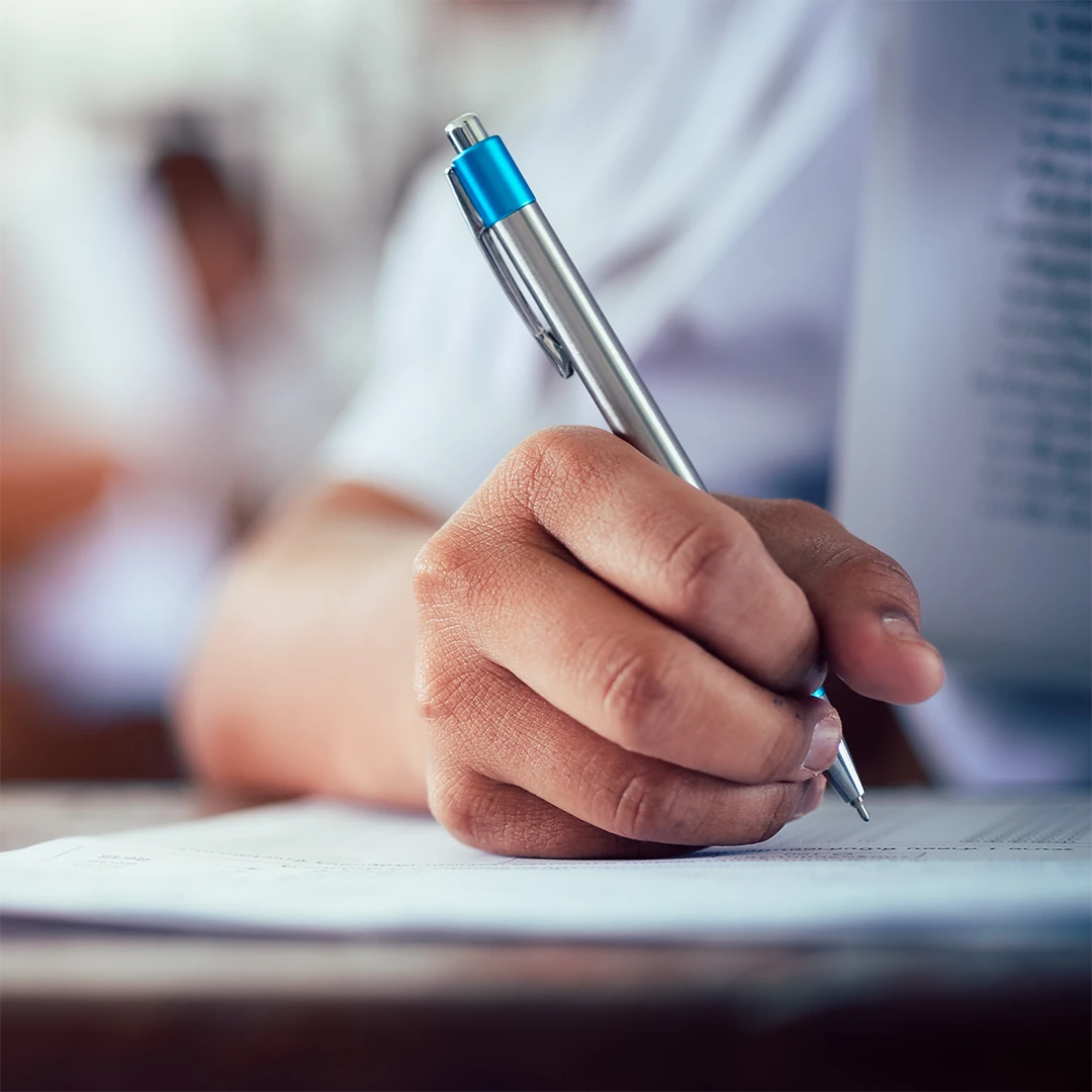 person hold a pen doing paper work image