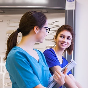two medical professionals talking image